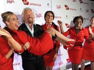 Virgin Group Founder Sir Richard Branson lifts a Virgin America staff member on April 22, 2013. (Virgin America/ Getty Images) Virgin Group Founder Sir Richard Branson lifts a Virgin America staff member on April 22, 2013. (Virgin America/ Getty Images)
