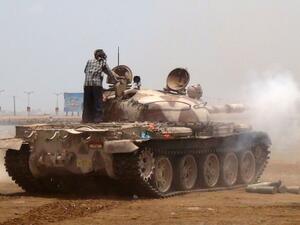 A Yemeni supporter of the separatist Southern movement stands on a tank firing during clashes with Houthis in Aden. (AFP/File)