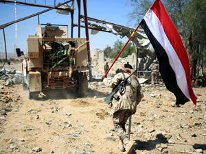 Loyalist forces carrying a Yemeni flag while on patrol in Marib. (AFP/File)