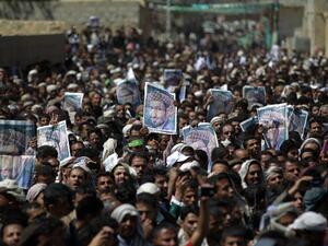 Supporters of the Shia Houthi movement hold portraits senior Houthi leader Lutf al-Quhom, who was killed in recent fighting, during his funeral on Feb. 18, 2016 in the capital Sanaa. (AFP/Mohammed Huwais)