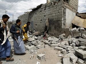 Yemeni men walk amid the ruins of a building in Yemen's Houthi rebel-held capital Sanaa on August 29, 2016, after it was reportedly hit by a Saudi-led coalition air strike. (AFP/Mohammed Huwais)