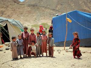 Yemeni children stand outside a tent at a makeshift camp for Internally Displaced Persons (IDPs) after they were forced to flee their homes due to the ongoing fighting in the country, in the Nehm region, west of Marib city, on May 8, 2016. (AFP/Abdullah al-Qadri)