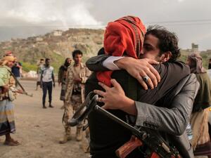 A Yemeni tribesman from the Popular Resistance Committees, supporting forces loyal to Yemen's Saudi-backed president, is greeted by a comrade after his release as part of a prisoner exchange with the Houthi rebels in the southwestern city of Taiz on June 1, 2016. (AFP/Ahmad al-Basha)