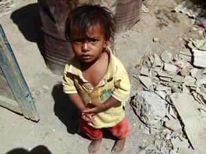A child in Yemen stands among rubble, AFP
