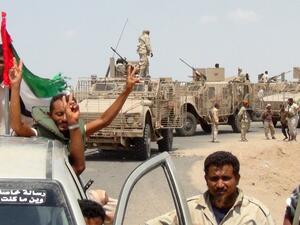 Armed Yemeni tribesmen from the Popular Resistance Committees, forces loyal to President Abd-Rabbu Mansour Hadi, flash the sign of victory on their armored vehicles on October 9, 2015 in the Dhubab district in Taiz province as they advance toward the Red Sea city of Mocha. (AFP/Nabil Hassan)