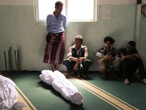 Yemenis mourn next to the bodies of victims who were killed in a rocket attack in a Taiz market during clashes between Hadi loyalists and Houthi rebels on Sept. 20, 2015. (AFP/Ahmad al-Basha)