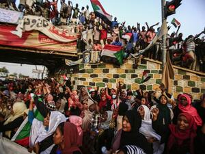Sudanese protesters chant slogans during a demonstration demanding a civilian body to lead the transition to democracy, outside the army headquarters in the Sudanese capital Khartoum  (AFP)