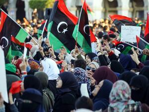 Libyan women wave national flags and chant slogans during a demonstration against strongman Khalifa Haftar in the capital Tripoli's Martyrs Square on April 12, 2019.  Mahmud TURKIA / AFP