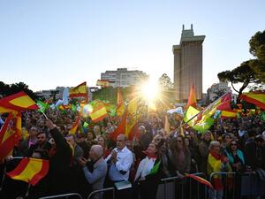 Supporters of Spanish far-right party VOX wave flags during the last campaign rally in Madrid (AFP)