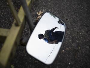 A Sri Lankan soldier is reflected on a mirror as he mans his position at a checkpoint in Colombo (AFP)