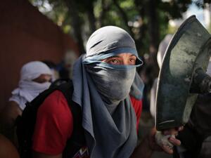 An opposition demonstrator clashes with soldiers loyal to Venezuelan President Nicolas Maduro  (AFP)