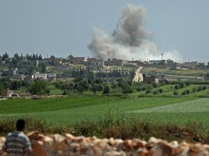 Smoke billows after reported shelling on the Syrian village (AFP)