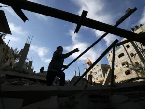 A Palestinian man checks the damaged to a structure hit by Israeli air strikes on Rafah in the southern Gaza strip  (AFP)