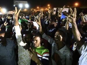 Sudanese protestors celebrate after an agreement was reached with the military council to form a three-year transition period for transferring power to a full civilian administration, in Khartoum (AFP)