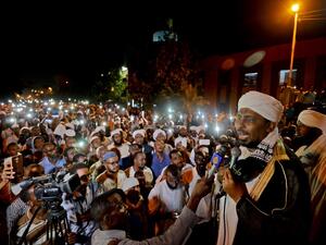 Sudanese hardline cleric Mohamed Ali Jazuli speaks as supporters of Islamist movements rally in front of the Presidential Palace in downtown Khartoum (AFP)