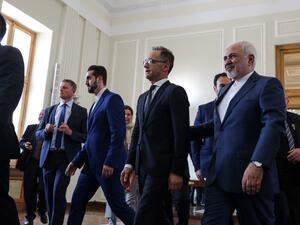 Iran's Foreign Minister Mohammad Javad Zarif (R) escorts his German counterpart Heiko Maas (C) after giving a joint press conference in the capital Tehran on June 10, 2019.  ATTA KENARE / AFP
