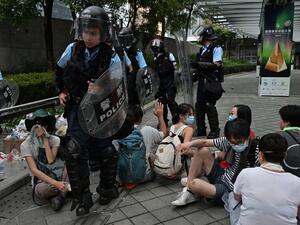 Police walk among protesters during a rally against a controversial extradition law proposal in Hong Kong on June 12, 2019 (AFP)
