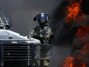A member of the Israeli forces looks on during clashes with Palestinian protesters (AFP)