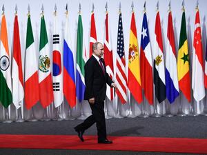 Russia's President Vladimir Putin arrives for the family photo during the G20 Osaka Summit in Osaka on June 28, 2019.  Brendan Smialowski / AFP