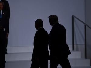 US President Donald Trump (R) walks with Russia's President Vladimir Putin before taking a family photo at the G20 Summit in Osaka on June 28, 2019.  Brendan Smialowski / AFP
