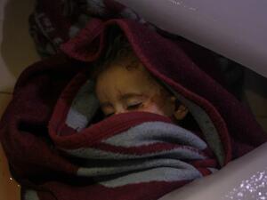 The body of a Syrian infant lies at a morgue following reported regime airstrikes on the town of Muhambal, in the northern Idlib province (AFP)