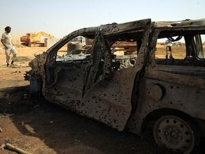 Damaged car at the site of a car bomb attack that targeted servicemen during the funeral of an ex-army commander in the Libyan city of Benghaz (AFP)