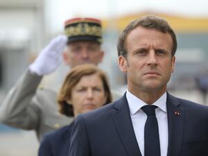French President Emmanuel Macron takes part in a military ceremony before the official launch of the new French nuclear submarine "Suffren" built by Naval Group at the French naval base (AFP)
