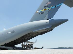 Members of the a U.S. Army carry team move the flag-draped transfer case holding the remains of Army Sgt. James G. Johnston of Trumansburg, New York, off a C-17 transport aircraft during a dignified transfer at Dover Air Force Base  (AFP)