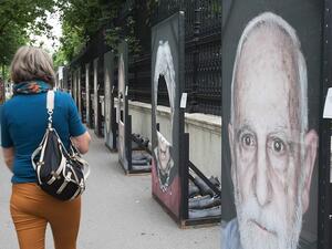 This woman stopped to look at the damage after 80 out of 200 portraits had their faces cut out amid a rising amount of anti-Semitism across Europe. Just days ago German officials warned Jews it was not safe to wear their skullcaps in all parts of the country due to the increasing threat of violence (AFP)