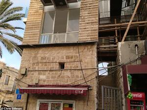 The building had ladders pitched up against crumbling walls, windows with no glass, and a flight of entrance steps that led to a nowhere (dailymail.co.uk)