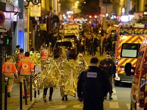 People being evacuated on rue Oberkampf near the Bataclan concert hall in central Paris (AFP)