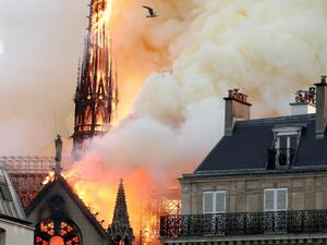 Smoke billows as fire engulfs the spire of Notre Dame Cathedral in Paris. (AFP)