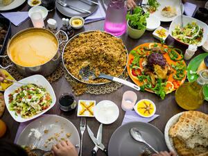 Top view of Muslim family gathering for eating iftar food in Ramadan (Shutterstock)	