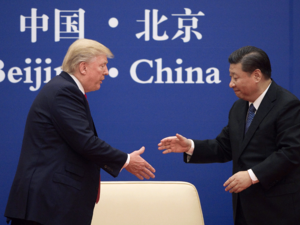 China's President Xi Jinping shakes hands with US President Donald Trump during a business leaders event at the Great Hall of the People in Beijing.