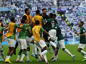 Saudi Arabia's midfielder #10 Salem Al-Dawsari (C) celebrates with teammates after scoring his team's second goal during the Qatar 2022 World Cup Group C football match between Argentina and Saudi Arabia at the Lusail Stadium in Lusail, north of Doha on November 22, 2022. (Photo by Khaled DESOUKI / AFP) Saudi Arabia
