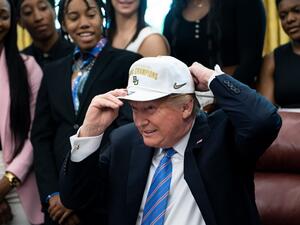 US President Donald Trump puts on a hat given to him by the 2019 NCAA Division I champions from Baylor University's women's basketball team April 29, 2019 at the White House in Washington, DC. (AFP)