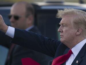 US President Donald Trump waves to supporters after arriving on Air Force One at the Palm Beach International Airport to spend Easter weekend at his Mar-a-Lago resort on April 18, 2019 in West Palm Beach, Florida. (AFP)