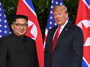 Standing in front of the flags of their two countries, Donald Trump and Kim Jong Un made history in Singapore (AFP Photo/SAUL LOEB)