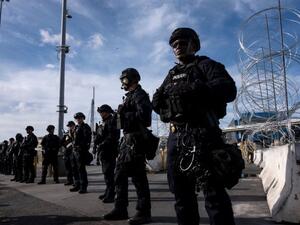 US border control agents stand in formation during a show of force as Central American migrants mass on the other side of the frontier (AFP Photo/Guillermo Arias)