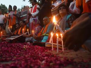 Pakistani civil society activists hold placards and candles to pay tribute to the Sri Lankan blasts victims, during a vigil in Lahore on April 23, 2019. (AFP/ File)