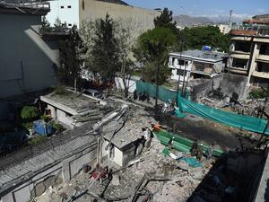 Afghan security forces gather at the site of an attack by Taliban militants, a day after the assault on a compound housing an international aid organisation, in Kabul on May 9, 2019. (AFP)