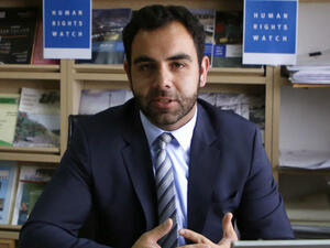 Human Rights Watch's Israel and Palestine director Omar Shakir, a US citizen, sits at his office in the West Bank city of Ramallah on May 9, 2018. (AFP/ File Photo)