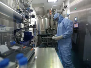 Pharmaceutical factory workers dressed in chemical safety suits work in the bioreactor room at the Actoverco plant in Karaj, about 40 kilometres (nearly 25 miles) west of Iran's capital Tehran, on February 18, 2020. AFP
