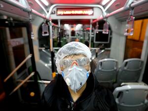 A Tehran Municipality worker cleans a bus to avoid the spread of the COVID-19 illness on February 26, 2020. Iran said Tuesday its coronavirus outbreak, the deadliest outside China, had claimed 15 lives and infected nearly 100 others -- including the country's deputy health minister. AFP