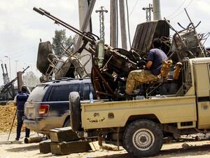 Fighters man turrets in technicals (pickup trucks mounted with turrets) stationed at a position held by forces loyal to Libya's Government of National Accord (GNA) in the suburb of Wadi Rabie. (AFP/ File Photo)