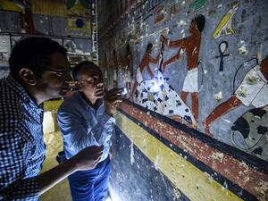 Mohamed Mujahid (L), head of the Egyptian mission which discovered the tomb of the ancient Egyptian nobleman "Khewi" dating back to the 5th dynasty (2494–2345 BC). (AFP)
