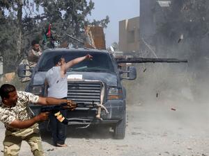 Libyan fighters loyal to the Government of National Accord (GNA) fire their guns during clashes with forces loyal to strongman Khalifa Haftar south of the capital Tripoli's suburb of Ain Zara, on April 20, 2019. (AFP)