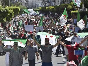 Algerian protesters march with national flags during an anti-government demonstration in the capital Algiers on May 10, 2019. (AFP)
