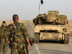Syrian soldier walk behind a military vehicle (AFP/File Photo)