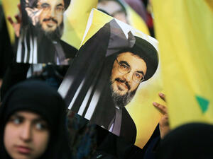 A Shiite supporter holds a poster showing Hassan Nasrallah, the head of Lebanon's militant Shiite Muslim movement Hezbollah. (AFP/ File)